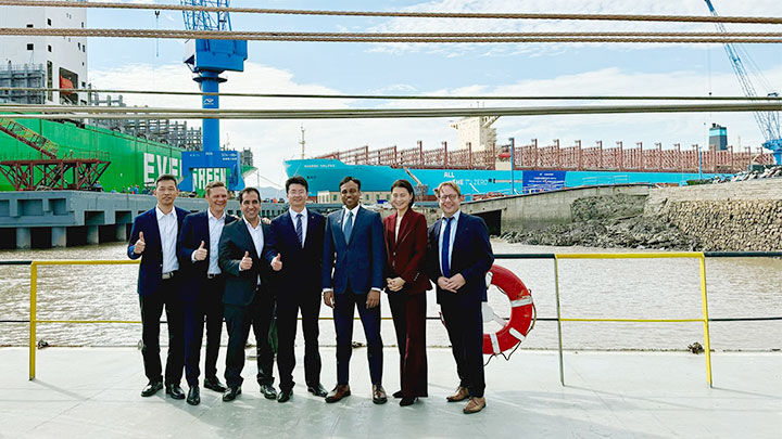 Represenatives of MAN Energy Solutions in front of Maersk Hallifax in Asia Pacific Dockyard