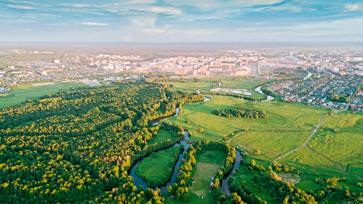 Aerial perspective of a forest and a neighboring town